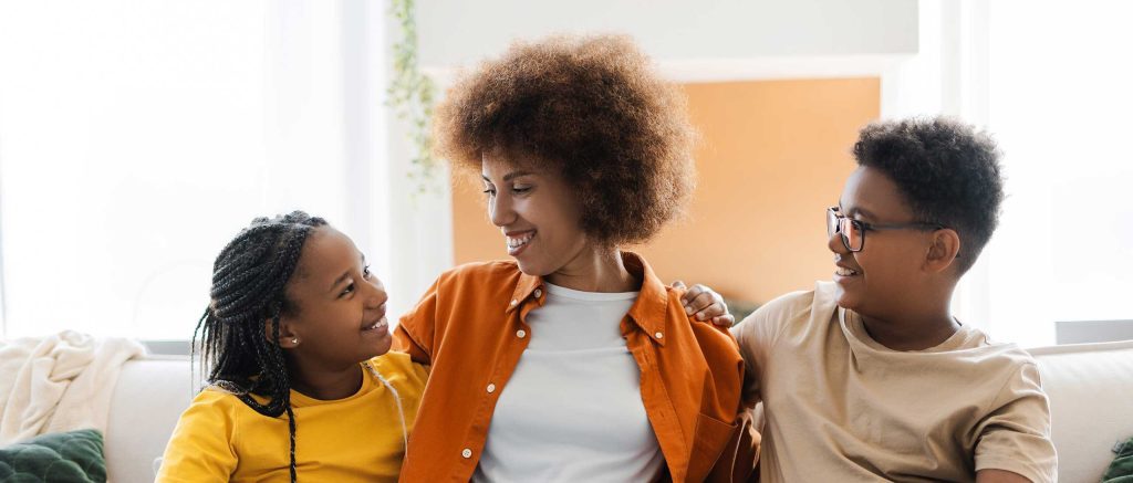 Happy young African American woman with her kids