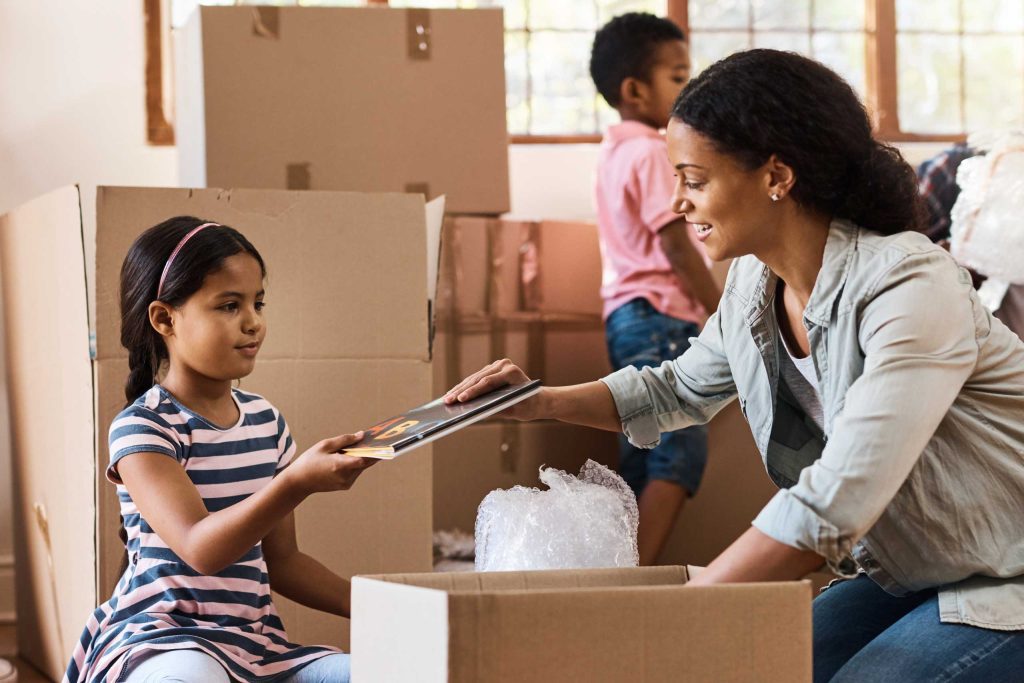 A young woman with two daughters getting ready to move