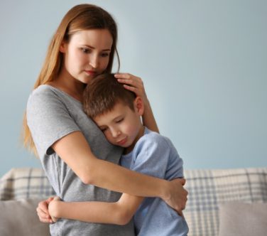 Mom embracing her son
